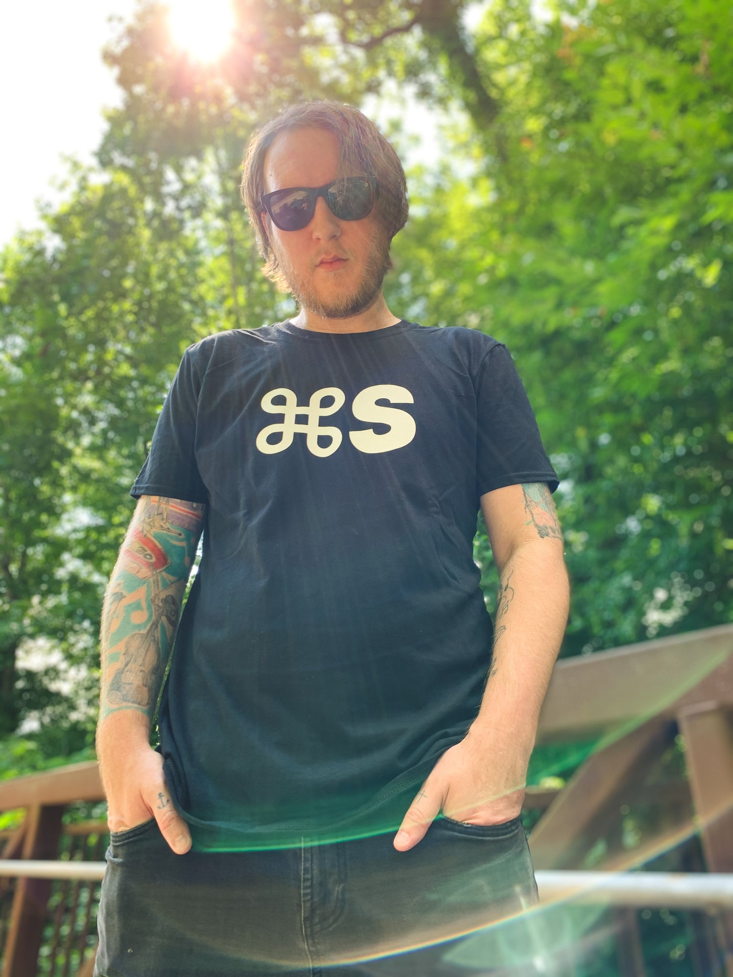 Man stands in park wearing black command s tee